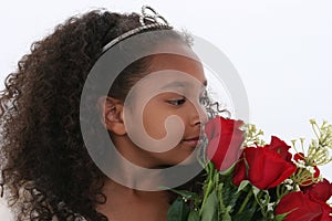 Beautiful Little Princess With Tiara Smelling Roses Over White