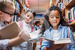 beautiful little schoolgirls looking for books