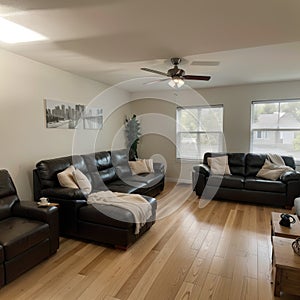 Beautiful living room interior with hardwood floors and fireplace in new luxury home Has view of kitchen hallway and loft area