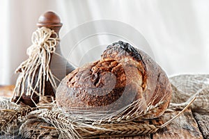 Beautiful loaves of bread on a leaven of white wheat on a plate on the edge of the canvas. Homemade cakes, handmade. Close up