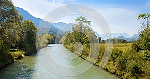 Beautiful Loisach river with green riversides and view to Zugspitze mountain