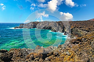 Beautiful lonely coastal lagoon landscape, rugged rough wild cliffs, turquoise water waves, blue sky -  Los Hervidereos, Lanzarote