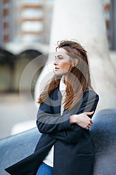 Beautiful lonely woman in city street