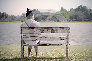 Beautiful lonely woman in frustrated depression sitting alone on