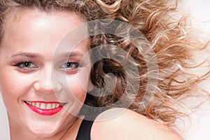 Beautiful long blond curly hair of young attractive woman