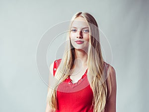 Beautiful long blonde hair woman in red dress natural over white photo