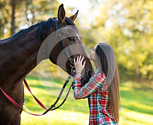 Beautiful long hair young woman with a horse