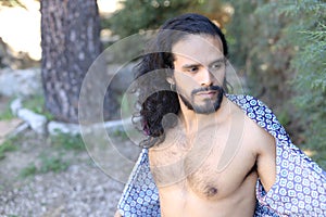 Beautiful long haired dancer showing muscular torso