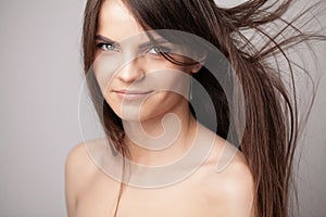 Beautiful long haired woman drying hair in bathroom