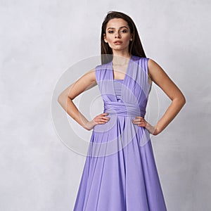 Young woman in purple bandeau maxi dress