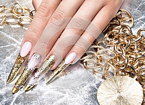 Beautiful long nails in a gold design with