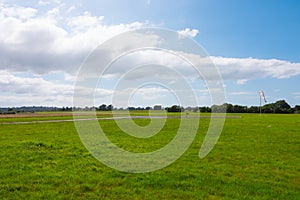 Beautiful long shot of a field used as a takeoff/landing runway for planes