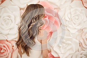 Beautiful long wavy hair style. Bride wedding hairstyle over flowers copyspace. Beauty hairdressing salon