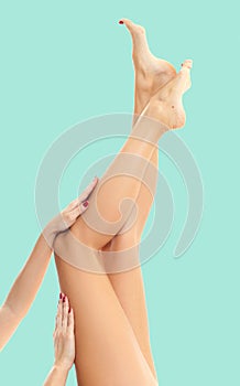 Woman`s legs with smooth skin after depilation on pastel background. photo