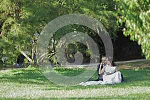 Stylish bride and groom at a park on their wedding day. Beautiful love story in nature, couple in love
