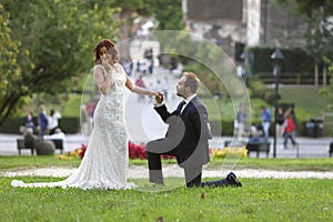 Stylish bride and groom at a park on their wedding day. Beautiful love story in nature, couple in love