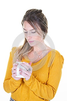 Beautiful lovely girl with cup mug of tea coffee resting pensive looking hot drink