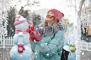 Beautiful lovely middle-aged girl with curly hair warm winter jackets stands ice rink background Town Square