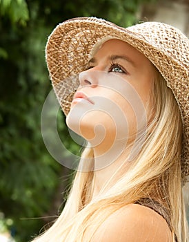 Beautiful lovely woman with straw hat posing