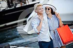 Beautiful loving couple carrying shopping bags and enjoying together.