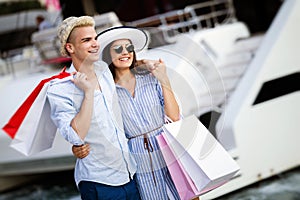 Beautiful loving couple carrying shopping bags and enjoying together.
