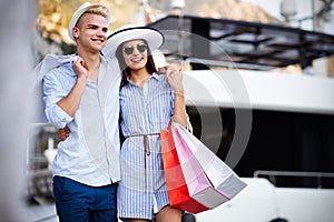 Beautiful loving couple carrying shopping bags and enjoying together.