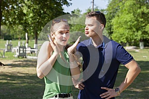 Beautiful loving couple flirting in the park on beautiful sunny day