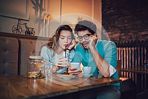 Beautiful loving couple sitting in a cafe drinking coffee