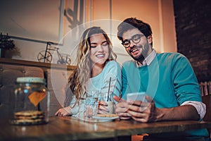 Beautiful loving couple sitting in a cafe drinking coffee