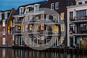 Beautiful and luxurious terraced houses at the canal, Dutch city architecture by night, Alphen aan den Rijn, The Netherlands photo