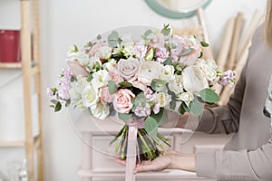 Beautiful luxury bouquet of mixed flowers in woman hand. the work of the florist at a flower shop. Wedding