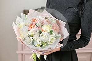 Beautiful luxury bouquet of mixed flowers in woman hand. the work of the florist at a flower shop.