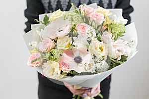 Beautiful luxury bouquet of mixed flowers in woman hand. the work of the florist at a flower shop. A small family