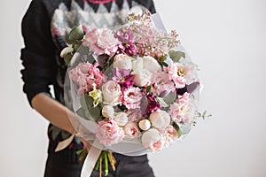 Beautiful luxury bouquet of mixed flowers in woman hand. the work of the florist at a flower shop. A small family