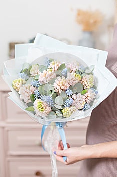 Beautiful luxury bouquet of pink hyacinths flowers in woman hand. the work of the florist at a flower shop.