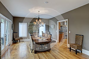 Beautiful luxury diningroom with wood and wicker chairs and hardwood floors and table photo