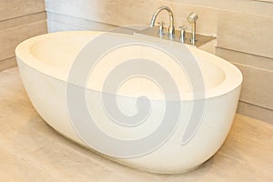 Beautiful luxury elegance white bathtub and water faucet decoration in bathroom