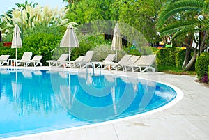 Beautiful Luxury Hotel Swimming Pool Resort with Umbrella and Chairs. Turkey, Side. Summer Vacation.