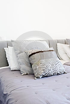 Beautiful luxury pillow on sofa decoration in livingroom interior Light Vintage gray colors