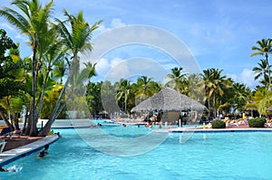 Beautiful luxury swimming pool at a tropical resort, People relax at the hotel.