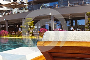 Beautiful luxury umbrella and chair around outdoor swimming pool in hotel and resort with coconut palm tree on blue sky