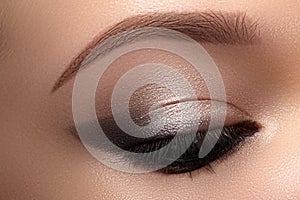 Beautiful Macro Eyes with Smoky Cat Eye Makeup. Cosmetics and Make-up. Closeup of Fashion Visage with Liner, Eyeshadows