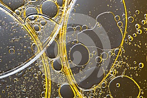 Beautiful macro photo of water droplets in oil with a grey background. Abstract art