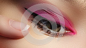 Beautiful Macro Shot of Female Eye with Classic Eyeliner Makeup. Perfect shape of eyebrows. Cosmetics and make-up