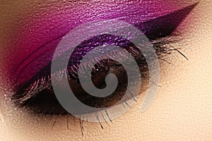 Beautiful macro shot of female eye with creative makeup. Bright