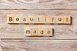 Beautiful made word written on wood block. Beautiful made text on table, concept