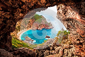 Beautiful magical view of the Gyali beach in Corfu, Greece through a hole in the rock. amazing places. popular tourist atraction photo