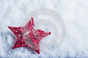 Beautiful magical vintage red star on a white snow background. Winter and Christmas concept.