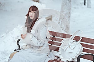 The beautiful maiden in the snow in winter photo