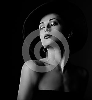 Beautiful makeup woman with elegant healthy neck, nude back and shoulder on black background in fashion hat with empty copy space